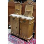 A pair of continental birds eye maple bedside cabinets, panelled backs with scroll carving and