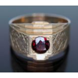 A hallmarked 9ct gold ring set with red paste, gross wt. 7.11g, size V/W.