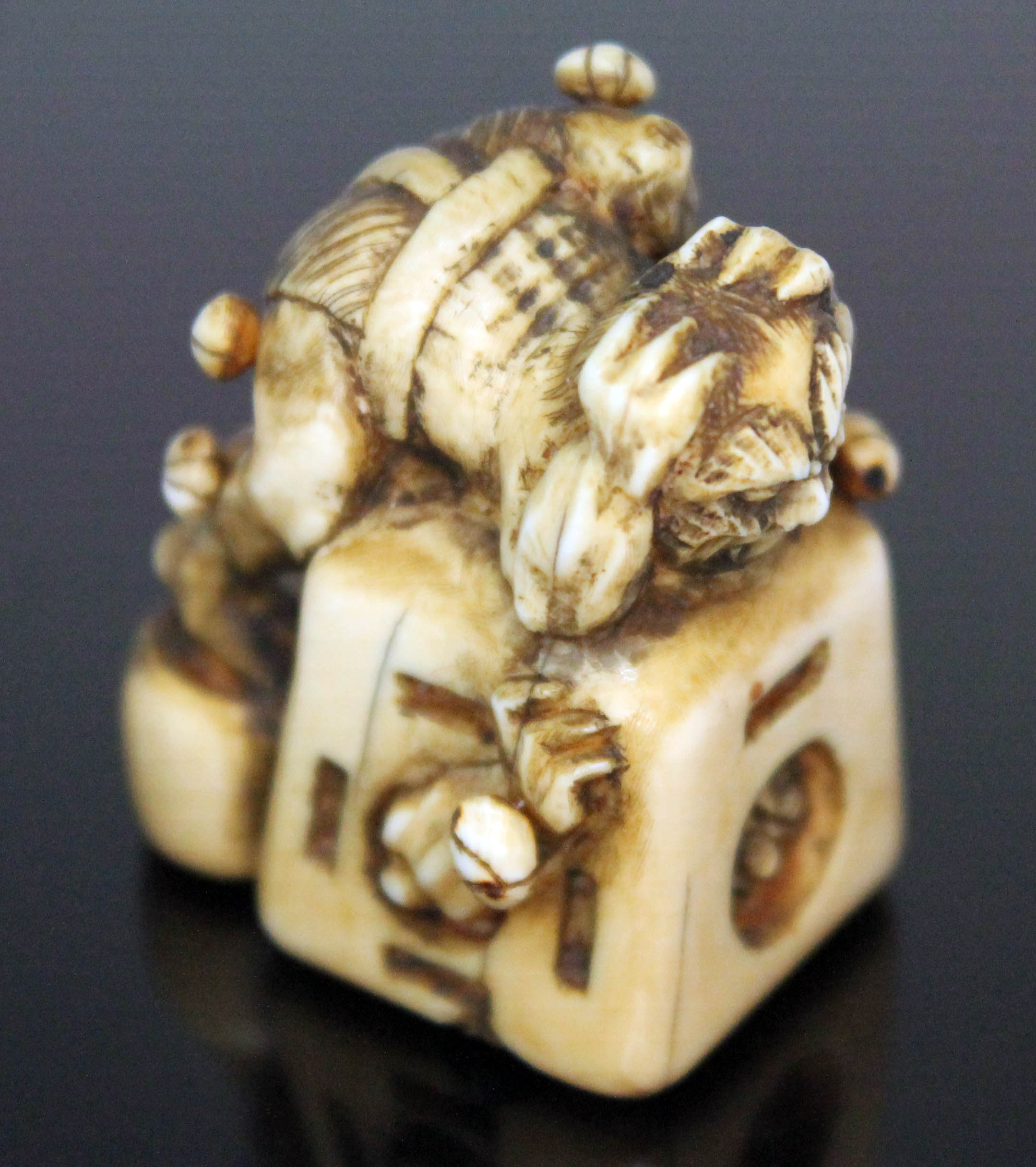 A Japanese carved ivory netsuke formed as an oni catcher on top of a box with protruding limbs, - Image 8 of 8