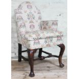An 18th century and later oak armchair of small proportions with domed back, scroll arms and