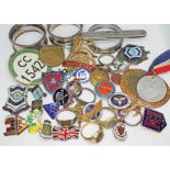 A mixed lot including a yellow metal ring indistinctly marked '9c' wt. 4.61g, military badges, three