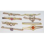 A group of eight hallmarked 9ct gold or marked 9ct bar brooches, various settings, gross wt. 12.01g.