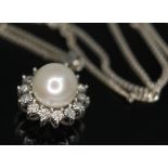 A cultured pearl and diamond pendant, diam. 13mm, marked 10K, on 18ct gold chain, length 44cm, gross