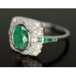 An emerald and diamond cluster ring, the cluster measuring approx. 11mm x 12mm, band marked 750,