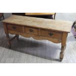 A 19th century three drawer pine dresser base, width 149cm, depth 49cm & height 74cm.