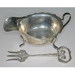 Two items of hallmarked silver: a sauce boat length 14.5cm and a toasting fork length 13.5cm, wt.