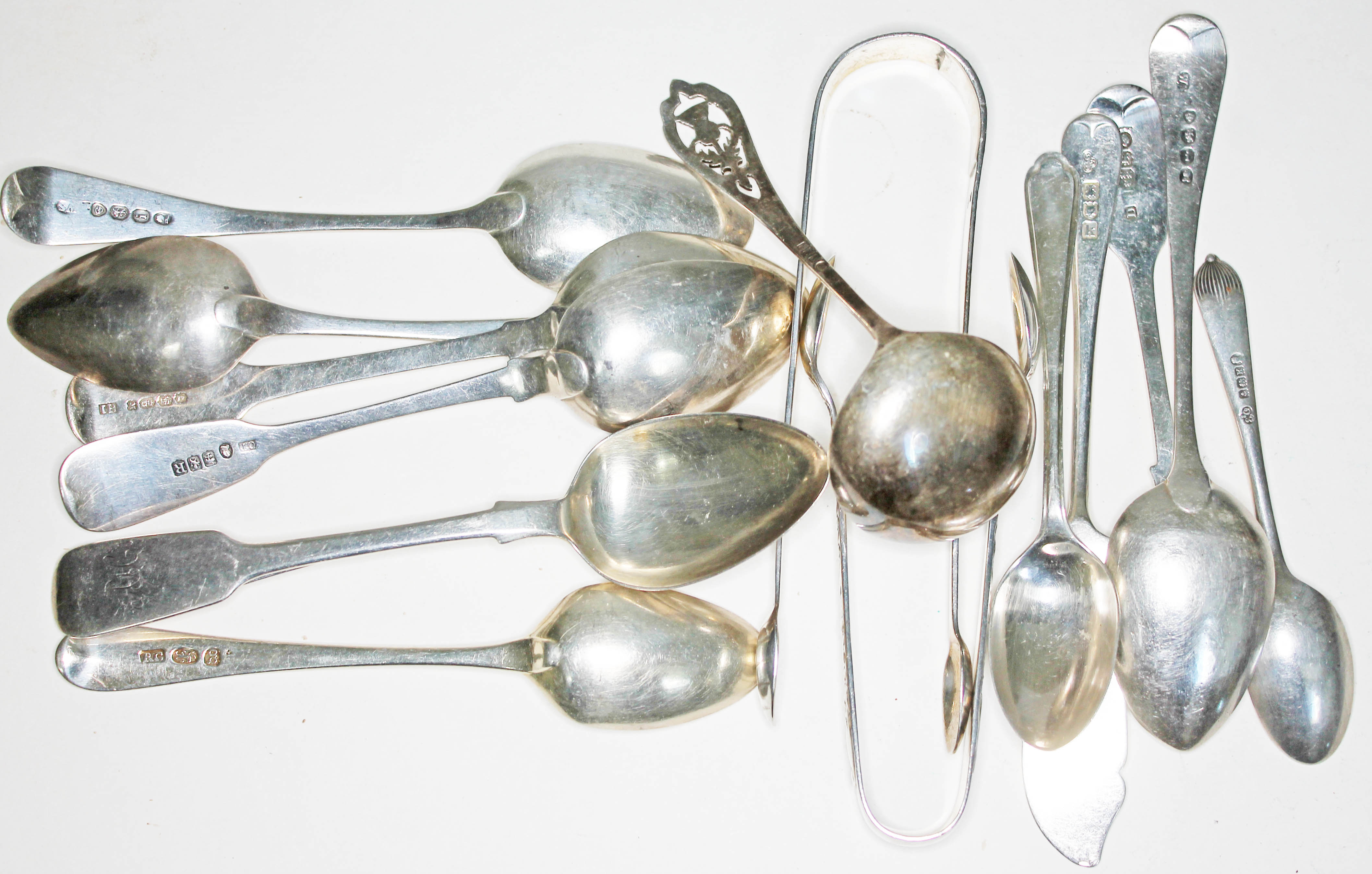 A mixed lot of hallmarked silver spoons and sugar tongs, various makers, Georgian and later, wt.