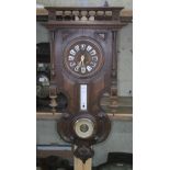 A Black Forest type wall clock with thermometer and barometer, length 83cm.