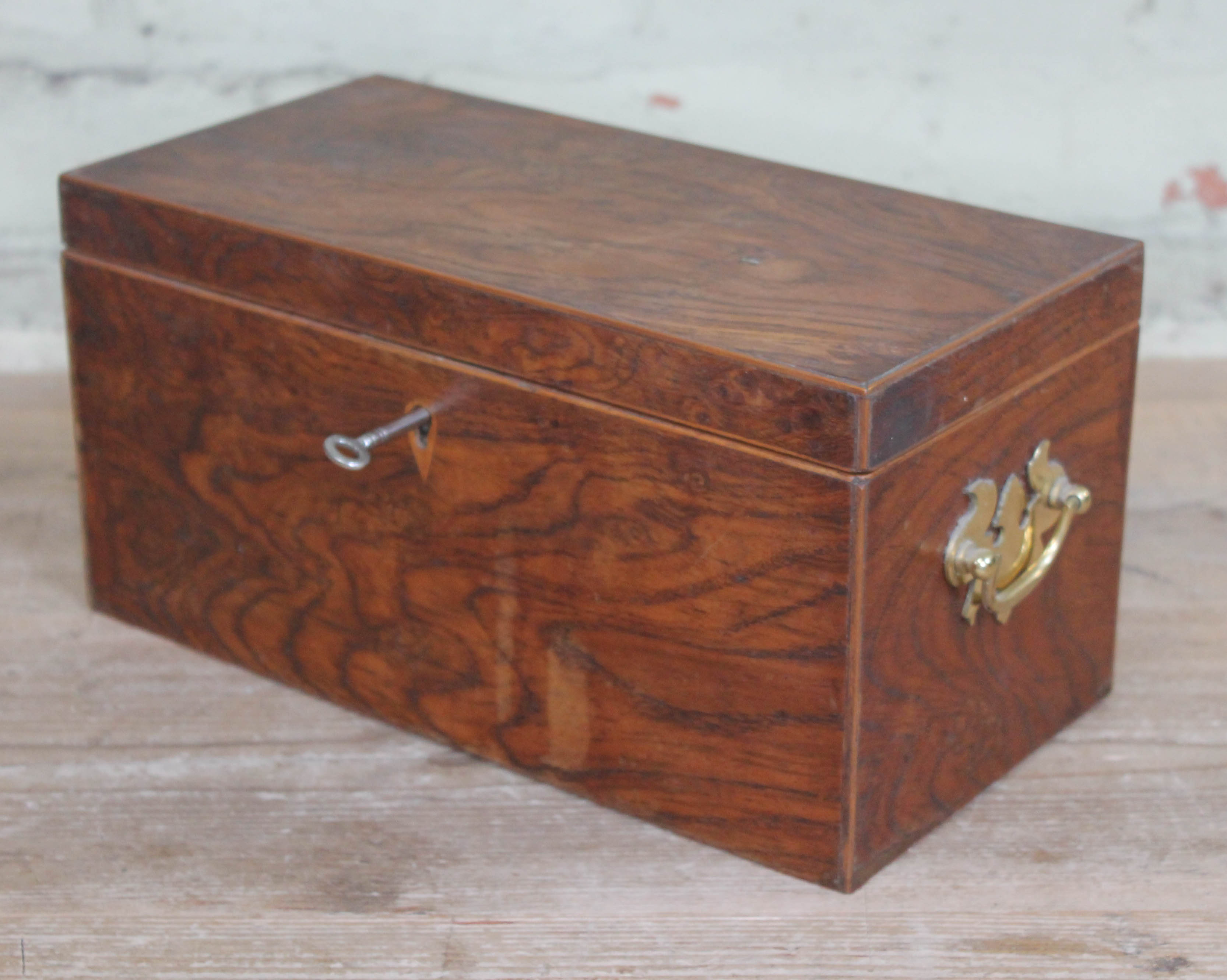 A pollard oak box with brass handles, length 31cm.