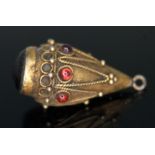 A Victorian Revivalist pendant set with garnet cabochons, unmarked, length 23mm, gross wt. 2.34g.