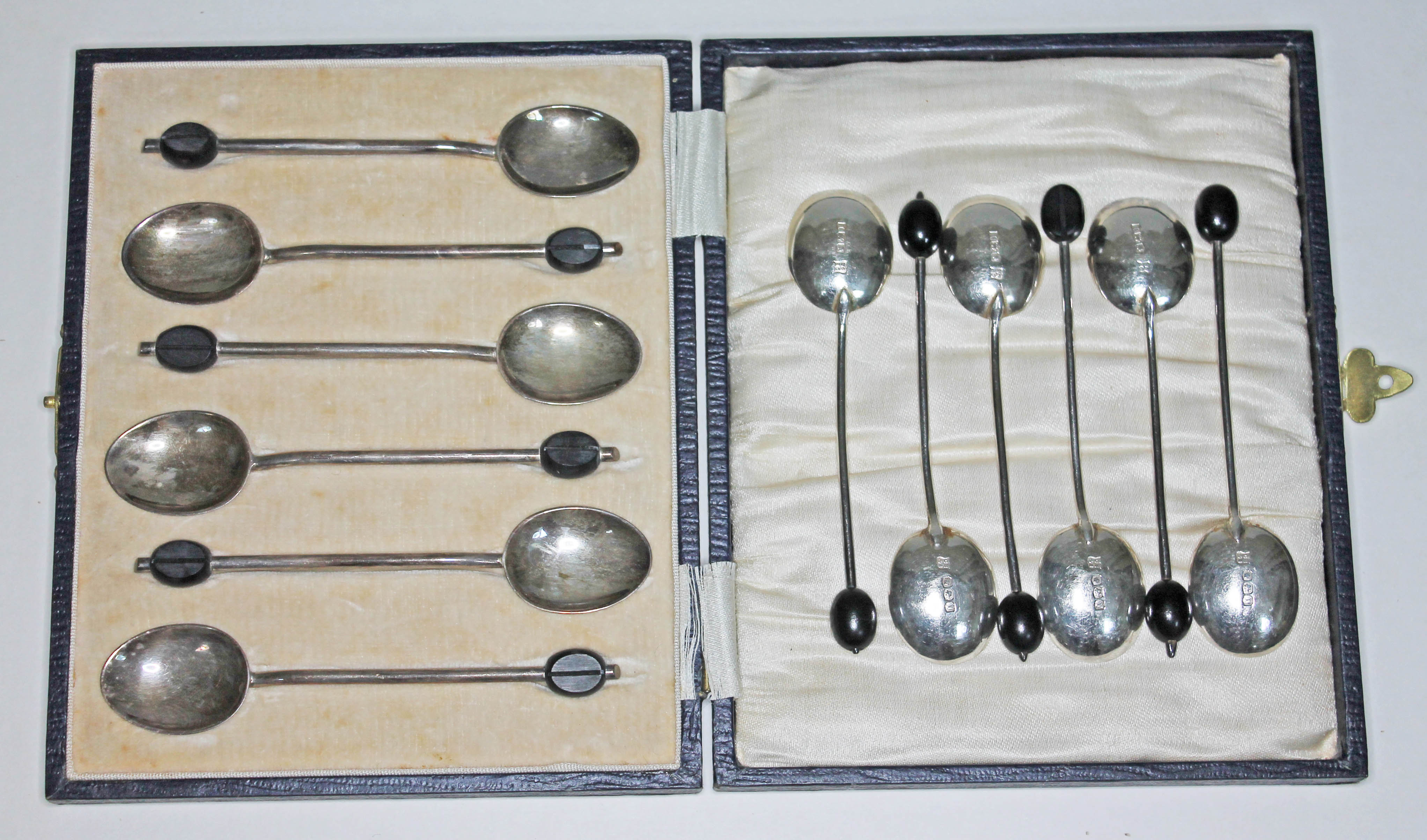 Two sets of six hallmarked silver bean spoons, one cased.