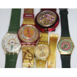 A group of five Swatch watches.