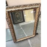 A rectangular mirror in gold/bronze coloured plastic frame