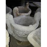 A pair of urn concrete planters.