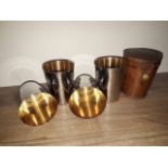 A set of leather cased silver plated hunting or stirrup cups.