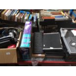 A large collection of laptop/tablet cases, accessories, keyboards, and a box of mixed electricals