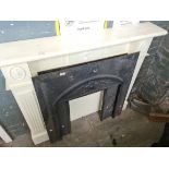 Two cast iron fire inserts and white wooden fire surround