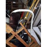 A mixed lot comprising golf clubs, step ladders, garden tools and an easel.