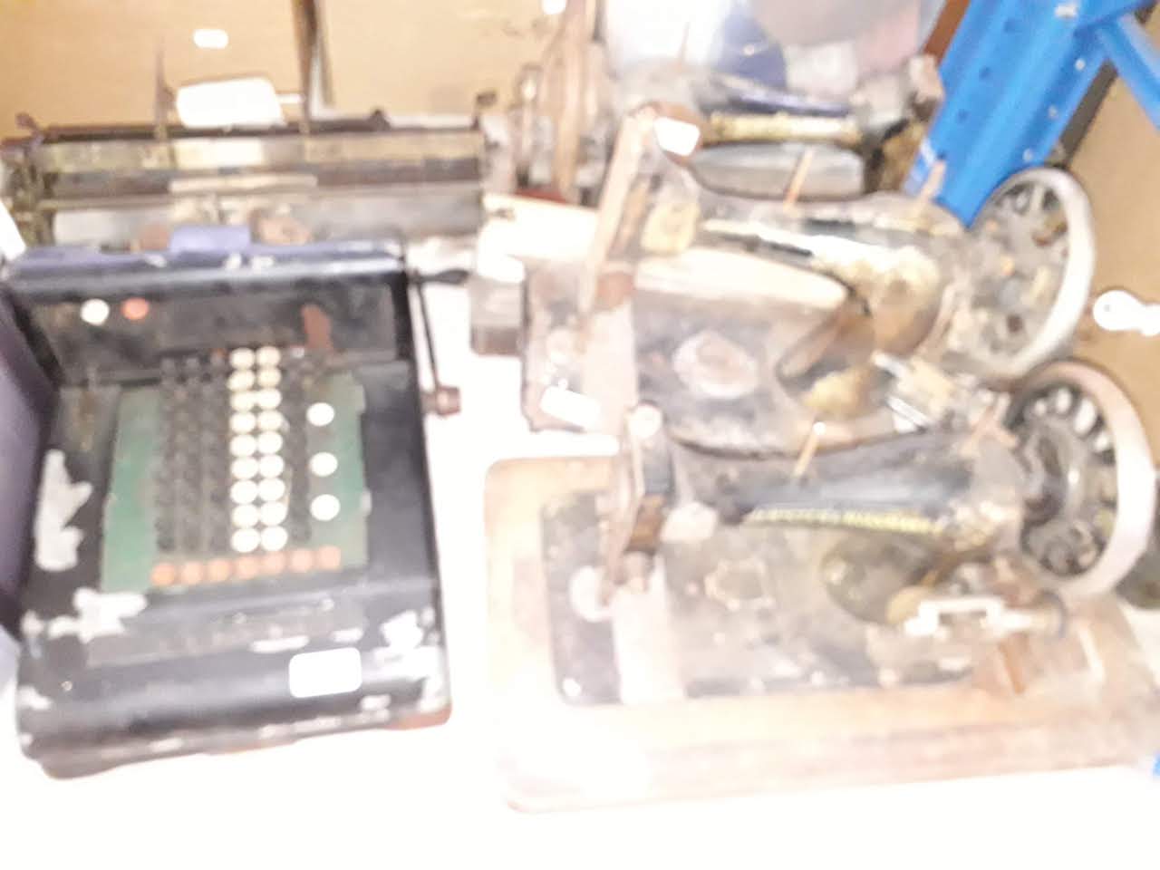 Three hand cranked sewing machines and an adding machine.
