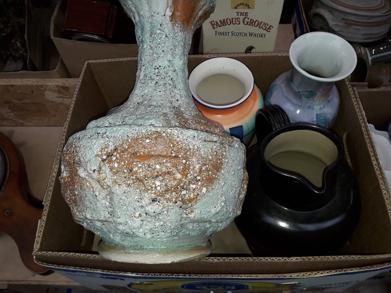 A box including a retro lava textured vase.