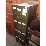 An old green metal filing cabinet.