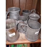 A box of pewter mugs