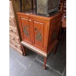 A Chinese style cocktail cabinet with slide out bottle storage.