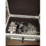 A wooden box of costume jewellery,.