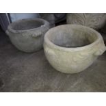 A pair of scroll handled concrete planters.