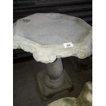 A concrete bird bath.