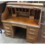 An early 20th century oak roll top desk, height 120cm, width 122cm, depth 66cm.