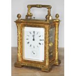 A French late 19th century gilt engraved and chased repeater carriage clock, the dial with Roman