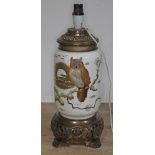 A Victorian Aesthetic pottery and gilt metal table lamp, decorated with an owl sat on a branch,