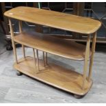 An Ercol model 361 blonde elm and beech bookcase trolley on castors, height 71cm, length 91cm, width