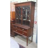 A good quality Edwardian bookcase with flared cornice, astral glazed cabinet top with adjustable