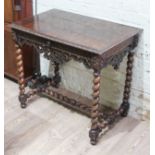 A 19th century carved oak side table with frieze drawer, twist legs and twist H frame stretcher,