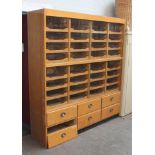 A large Haberdashery cabinet, 32 interior drawers with sliding glass above six lower drawers with