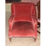 A late Victorian armchair by Gillows, upholstered in red, oak cabriloe legs and brass castors,