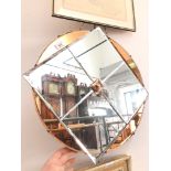 An Art Deco mirror with amber glass panels, diameter 52cm.