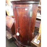 A Georgian mahogany bow front corner cabinet