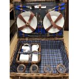 A picnic basket with partial set inside