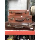 Three graduated leather vintage suitcases