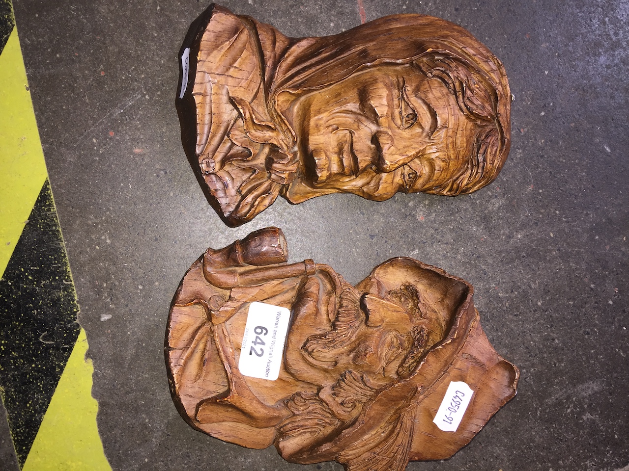 A pair of wood carved faces