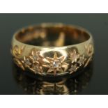 An Edwardian diamond cluster ring, six diamonds set with stars, scroll shoulders, sponsor's mark '