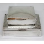 Two hallmarked silver cigarette boxes, lengths 9cm & 12cm. Condition - various dings etc.