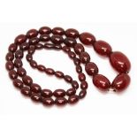 A graduated cherry bakelite necklace, the oval beads ranging in length from 10mm to 30mm, gross