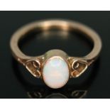 A ring set with an oval precious opal cabochon, band unmarked, gross wt. 2.10g, size N.