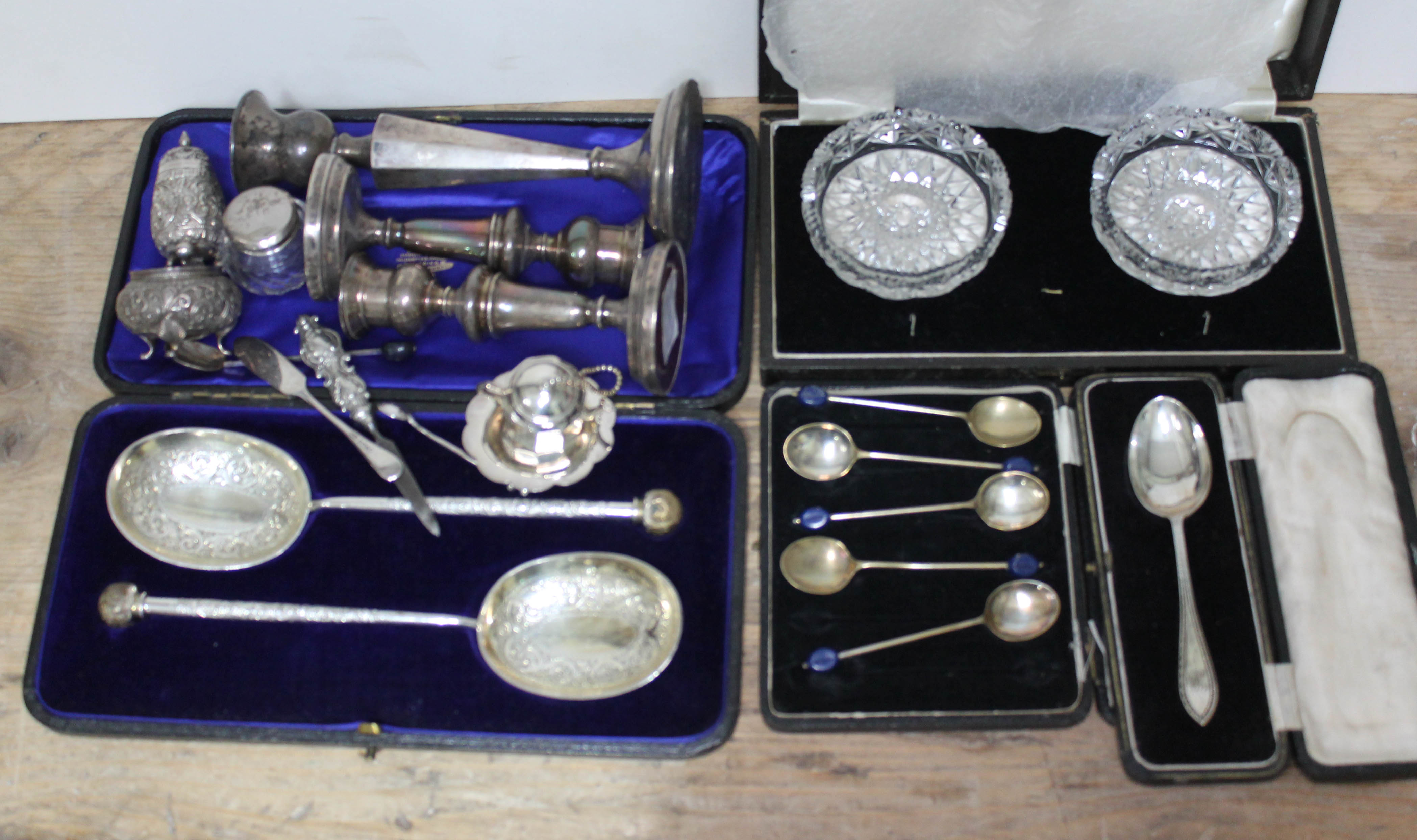 Assorted hallmarked silver comprising three candlesticks, a cased spoon, together with various