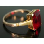 A dress ring set with a rectangular cut synthetic ruby, marked '9ct', gross wt. 2.24g, size L/M.