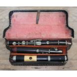 A late 19th/early 20th century nickel mounted ivory and rosewood flute with case. Condition -